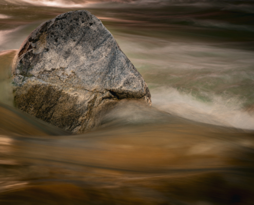 Wasser eines Bergbaches, welches einen Stein umfliesst, 1. Bild einer Serie